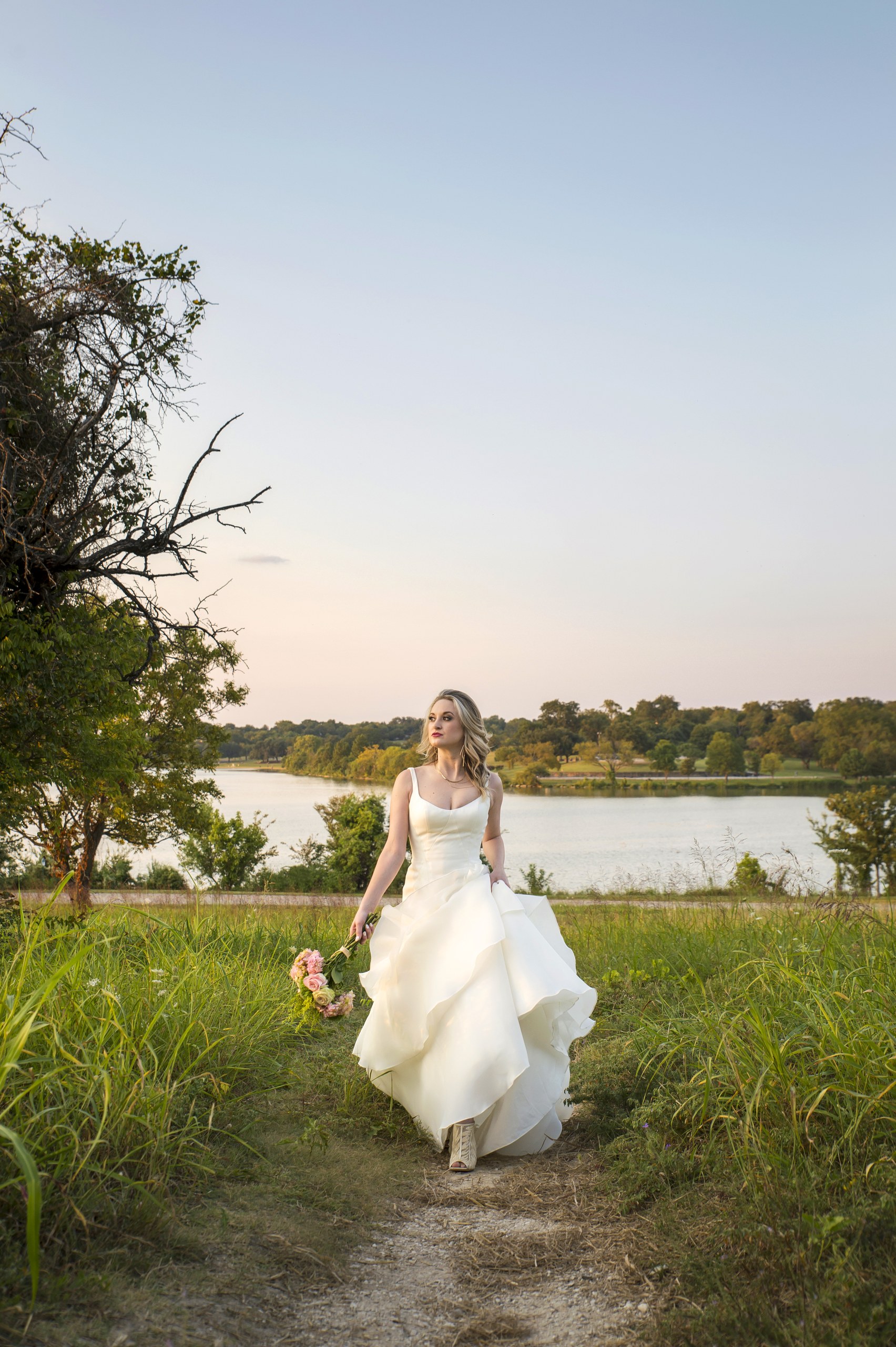 A bride at golden hour on the shore of White Rock Lake, Dallas