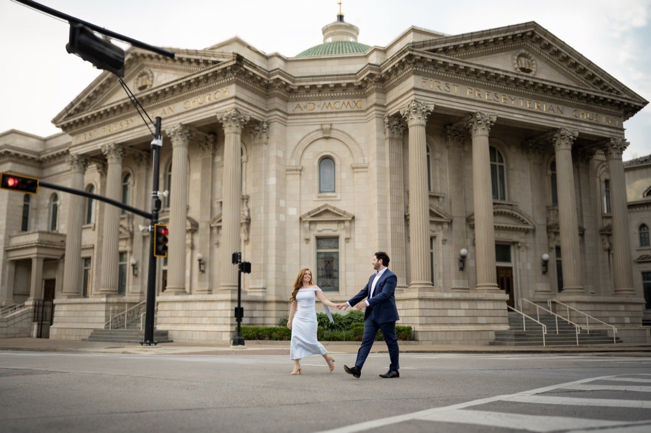 An engaged couple beneath the architecture of downtown Dallas